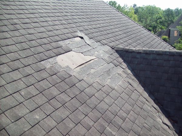 Roof with missing and cracked shingles