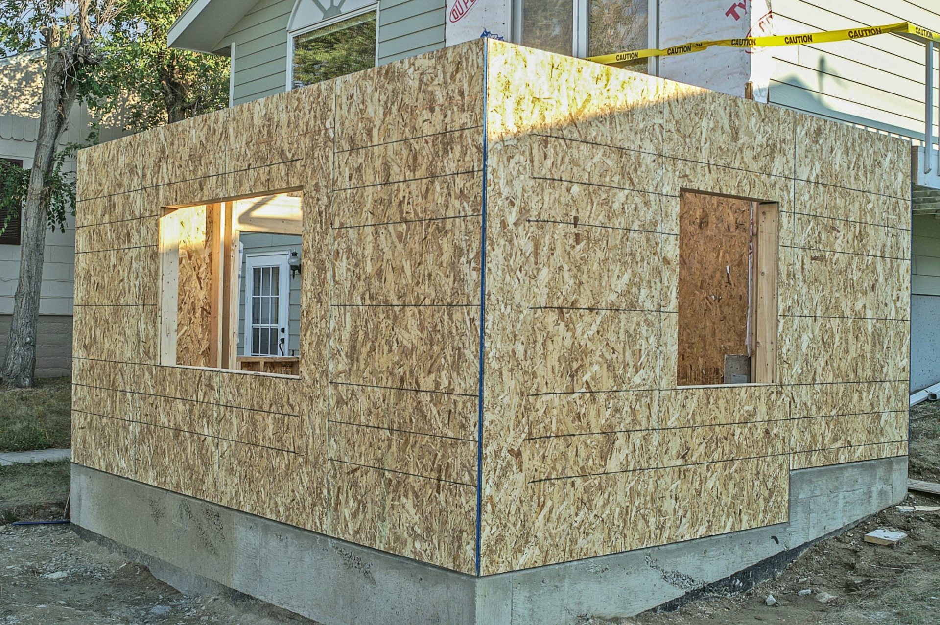 A house addition under construction with plywood walls.
