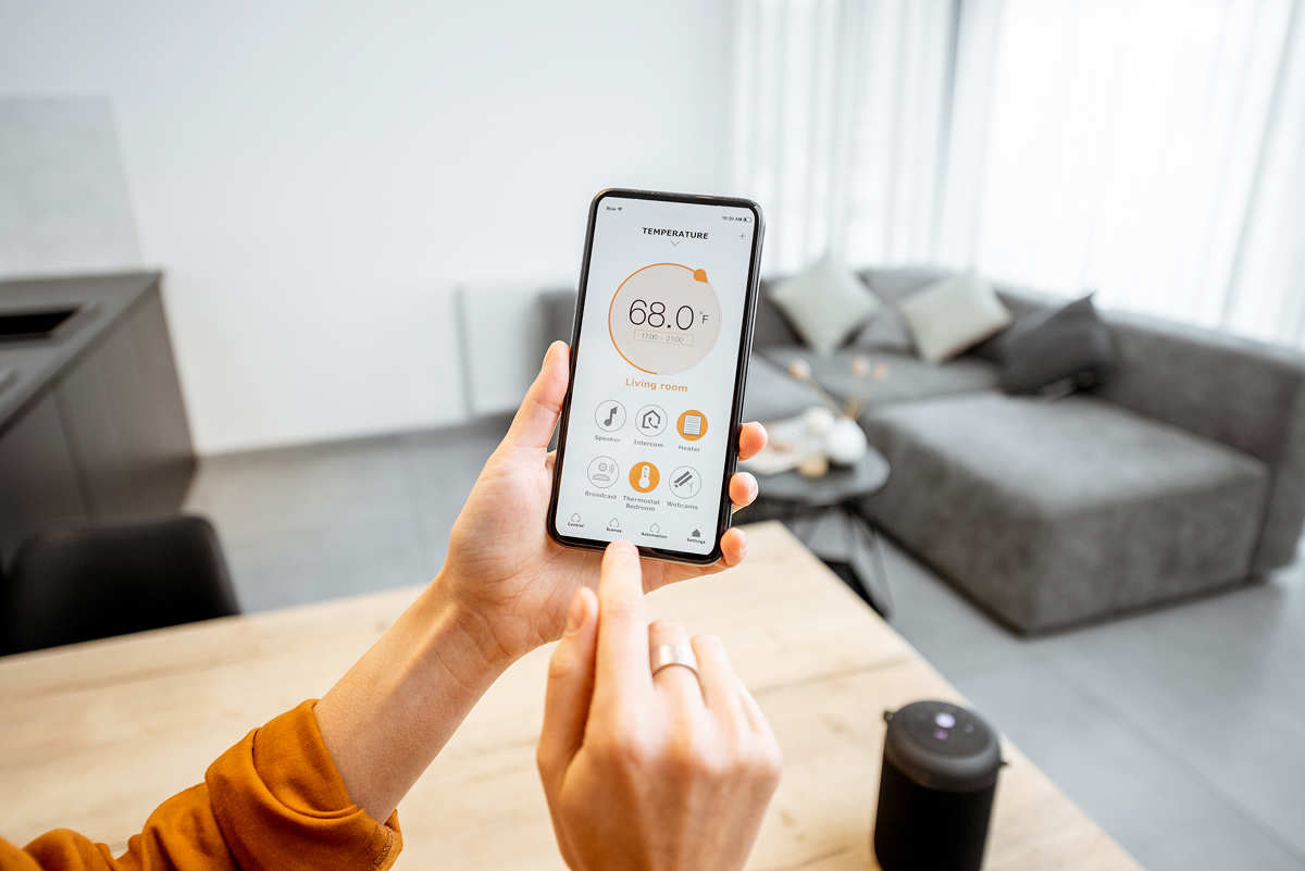 A person controlling smart home devices on their smartphone
