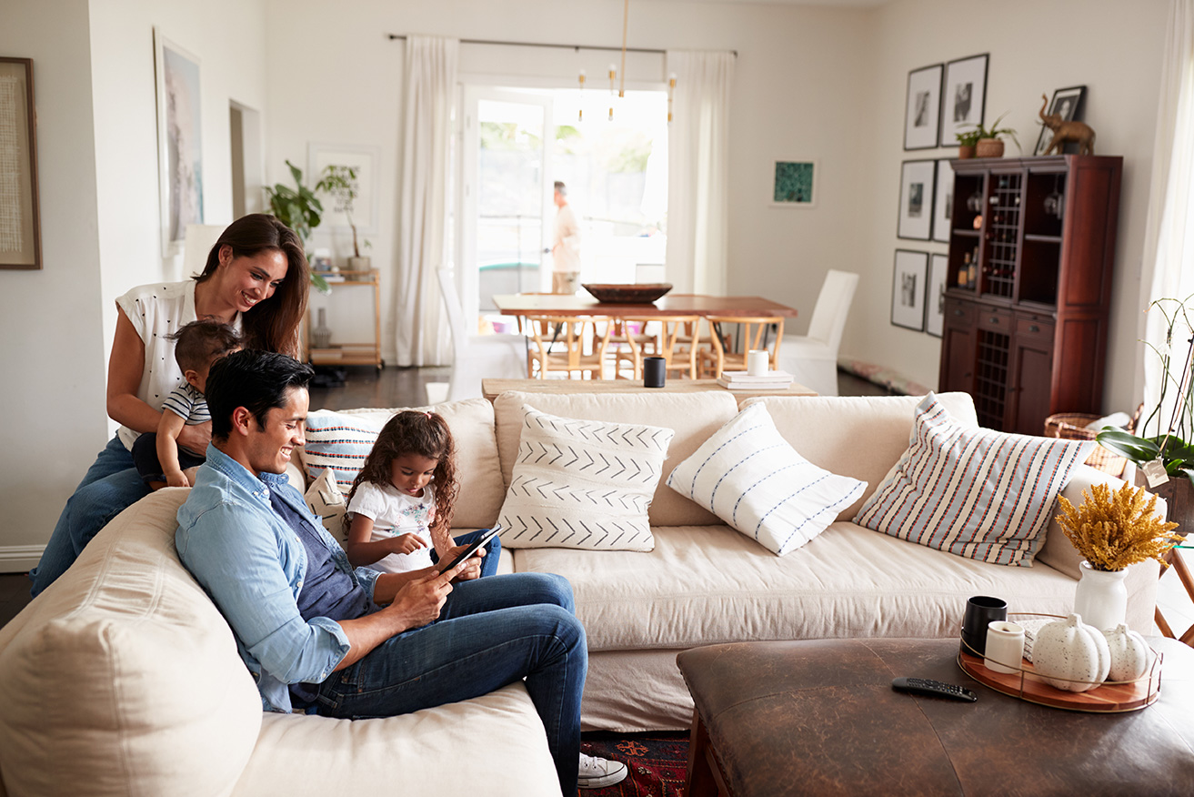 A family of three spending time together on the couch