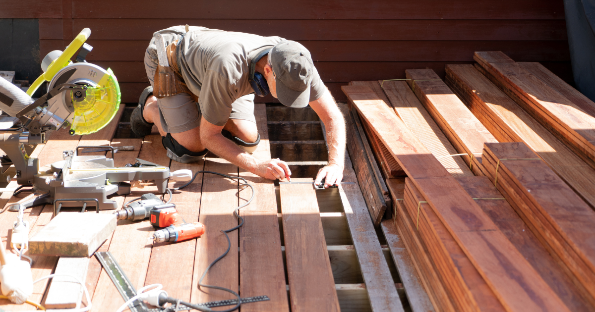 Man working on train tracks. A man is shown in a grayscale image.