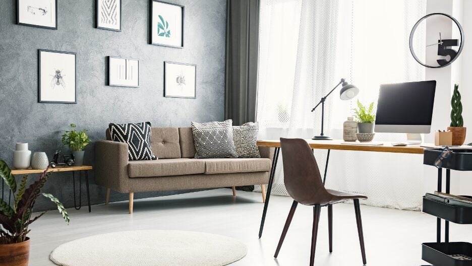 A modern home office with a comfortable seating area and desk