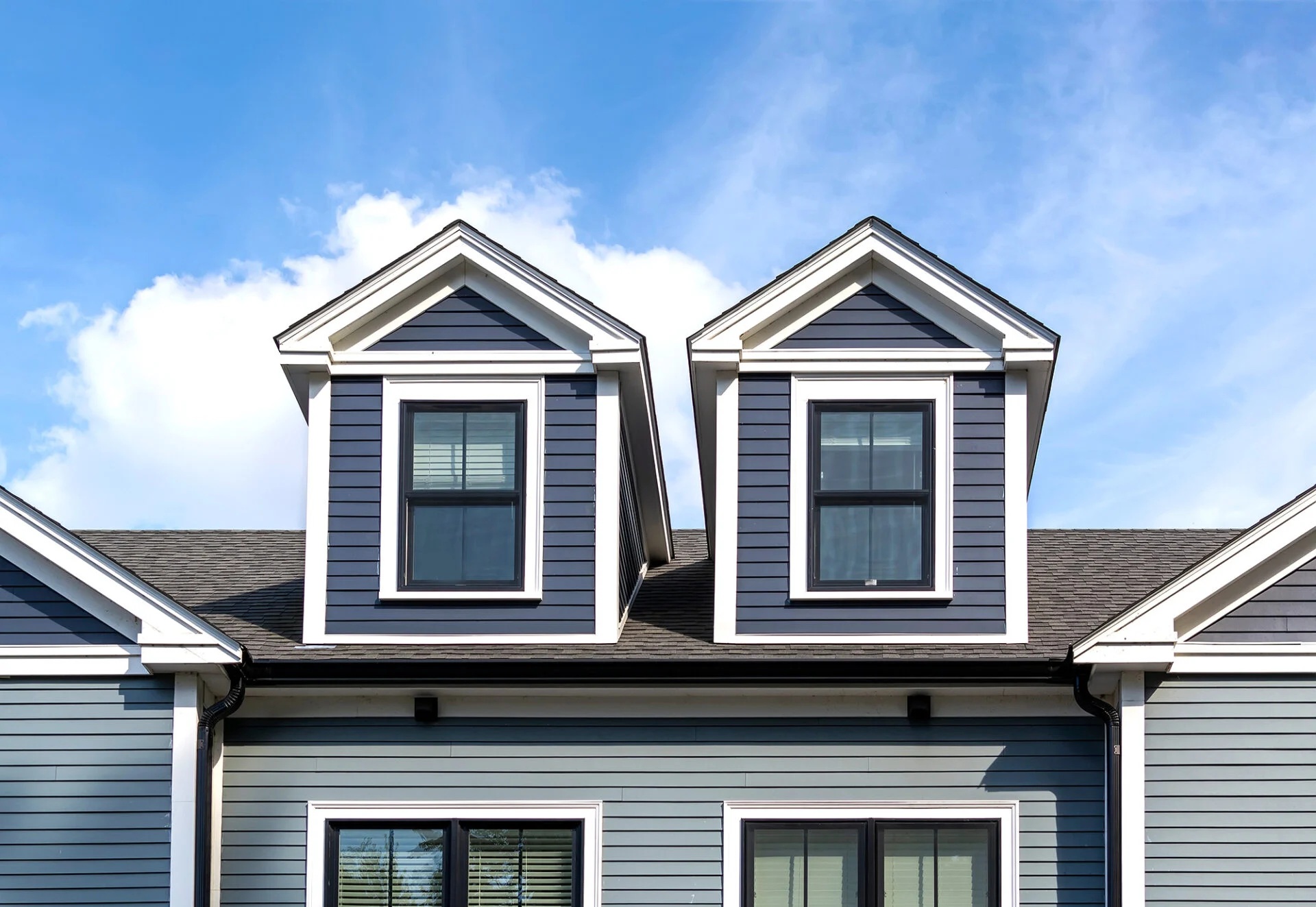 a blue house with dormer windows