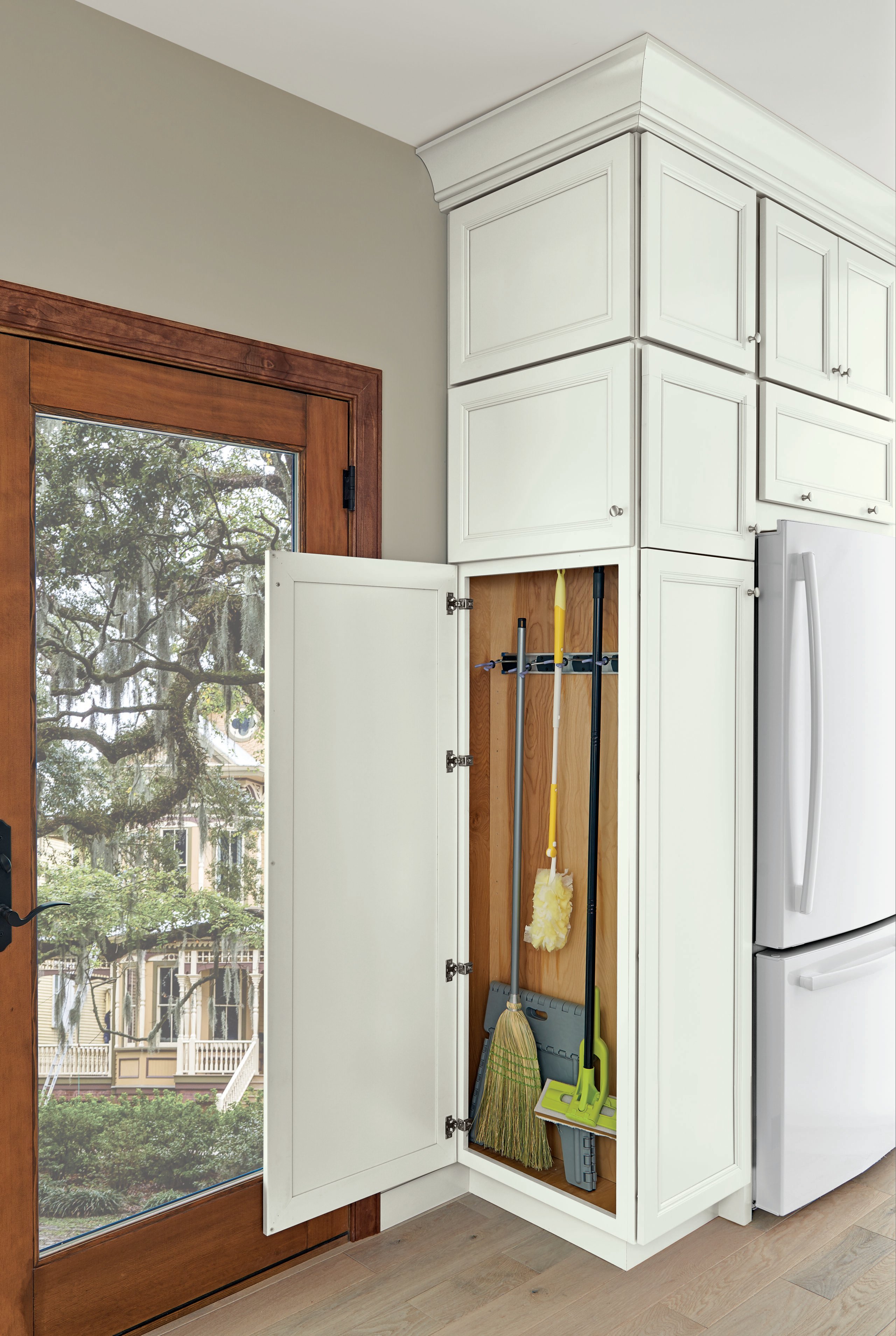 A kitchen cabinet with cleaning supplies blends seamlessly into cabinet storage