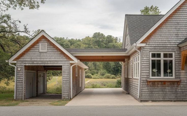 A modern house with a gray exterior and attached garage.