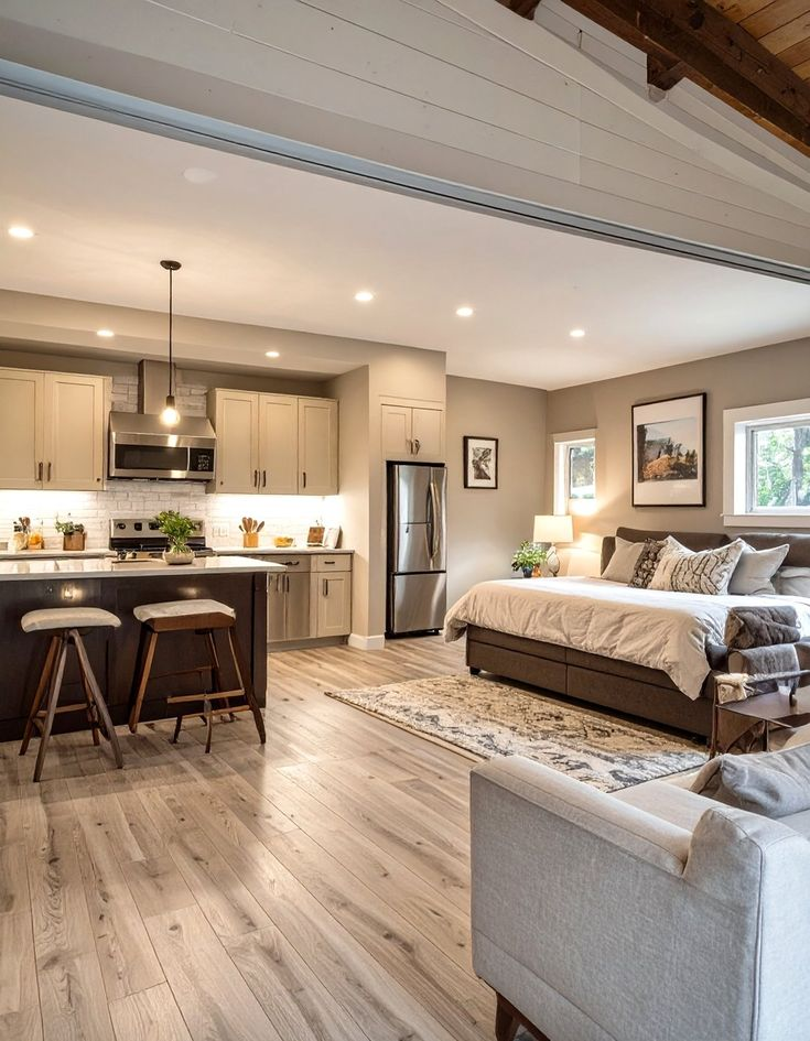 A modern studio apartment with kitchen, bedroom and living area.