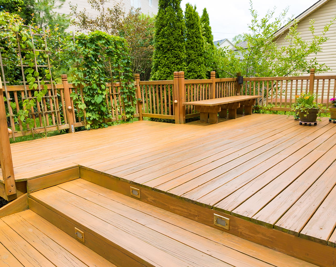 A wooden deck with stairs and garden
