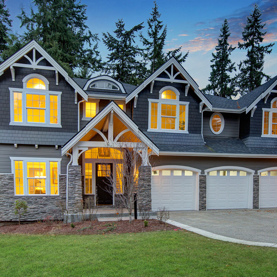 Luxury House with Gray Exterior and White Trim Large house with gray exterior and white trim. The house has a stone porch and three car garage.